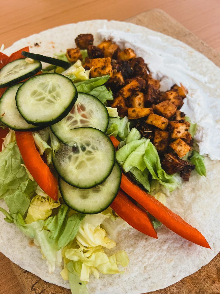 open vegan wrap, cucumber, tofu, red bell pepper, salad greens